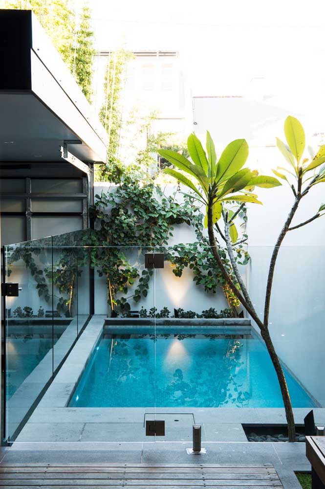 Take advantage of the area between the wall and the side of the house to build a pool.  To make the space safer, especially for those with children at home, make a glass cover.