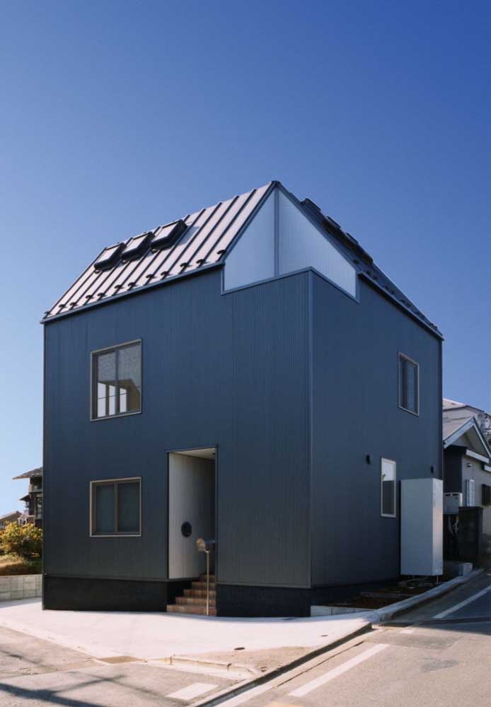 Casa pequena em formato quadrado valorizada pela cor usada na fachada: um tom sobre tom de azul