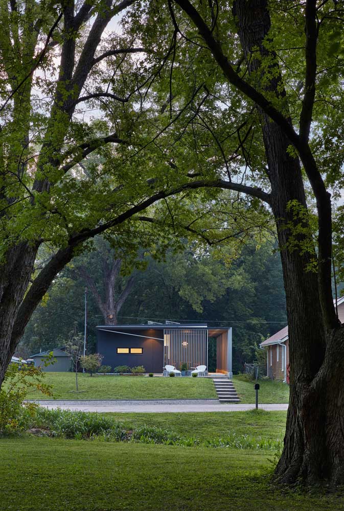 Casa pequena e moderna com varanda na frente; um convite para momentos de descanso