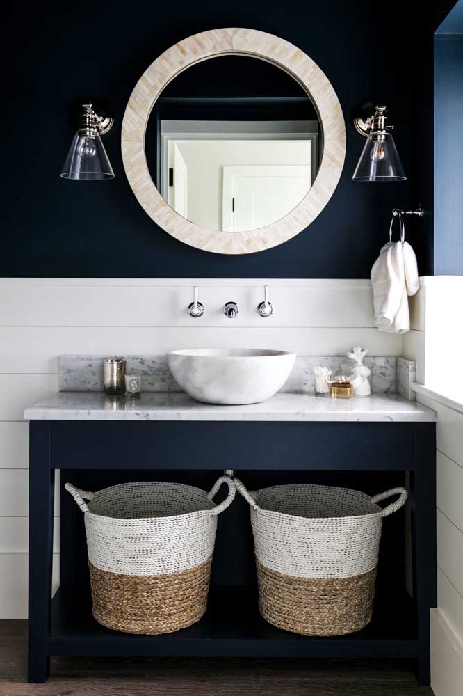 Nesse lavabo, o tom escuro e marcante de azul marinho forma um contraste perfeito com o branco