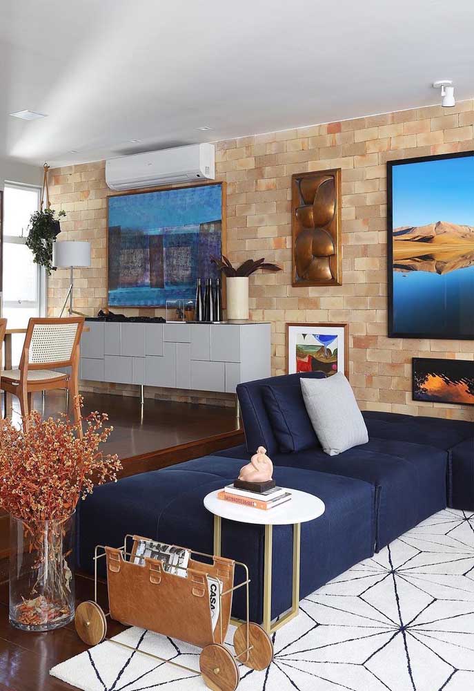 O sofá azul marinho reforça a ideia acolhedora e aconchegante da cor