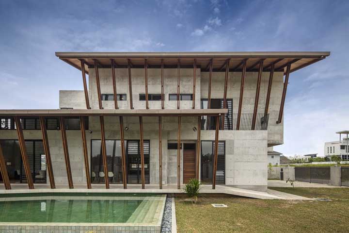 O terreno grande ganhou uma casa com arquitetura moderna e diferenciada, além da piscina próxima ao jardim