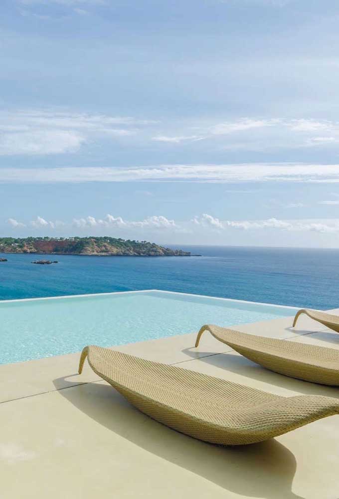 Essa casa com vista para o mar contracenou perfeitamente com a piscina com borda infinita; a integração da piscina com a paisagem é de arrancar suspiros