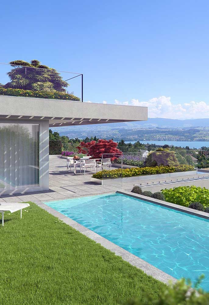 O gramado ao redor da piscina de fibra valoriza o projeto