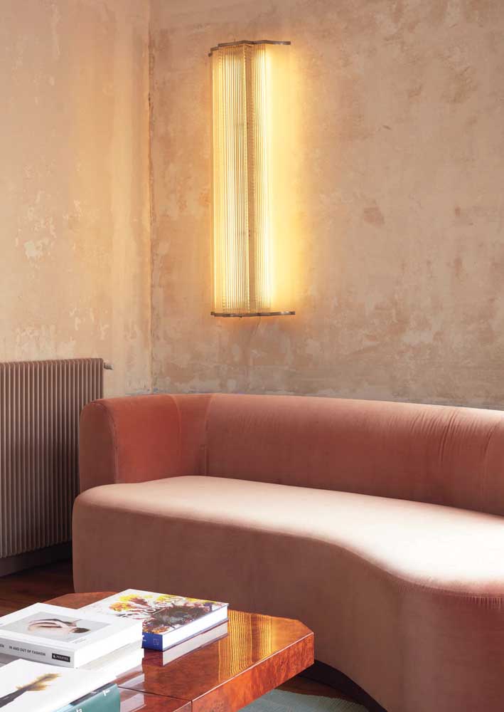 Para deixar tudo ainda mais acolhedor, instale uma lâmpada amarela perto do sofá rosa