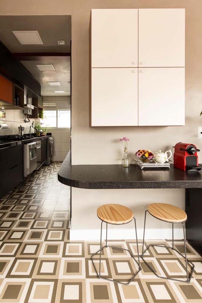 A bancada de pedra que vem da cozinha faz a curva para a sala e abriga um cantinho do café suspenso moderno e minimalista.