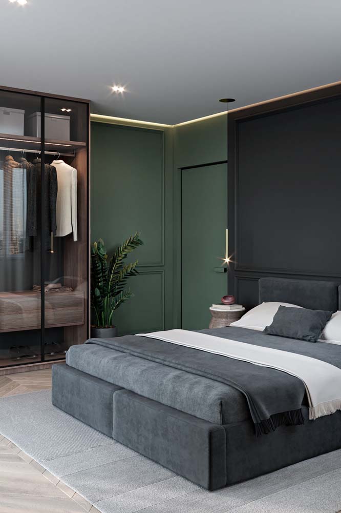 A combinação de verde musgo, preto, branco e madeira a criar um ambiente sóbrio e masculino neste quarto.