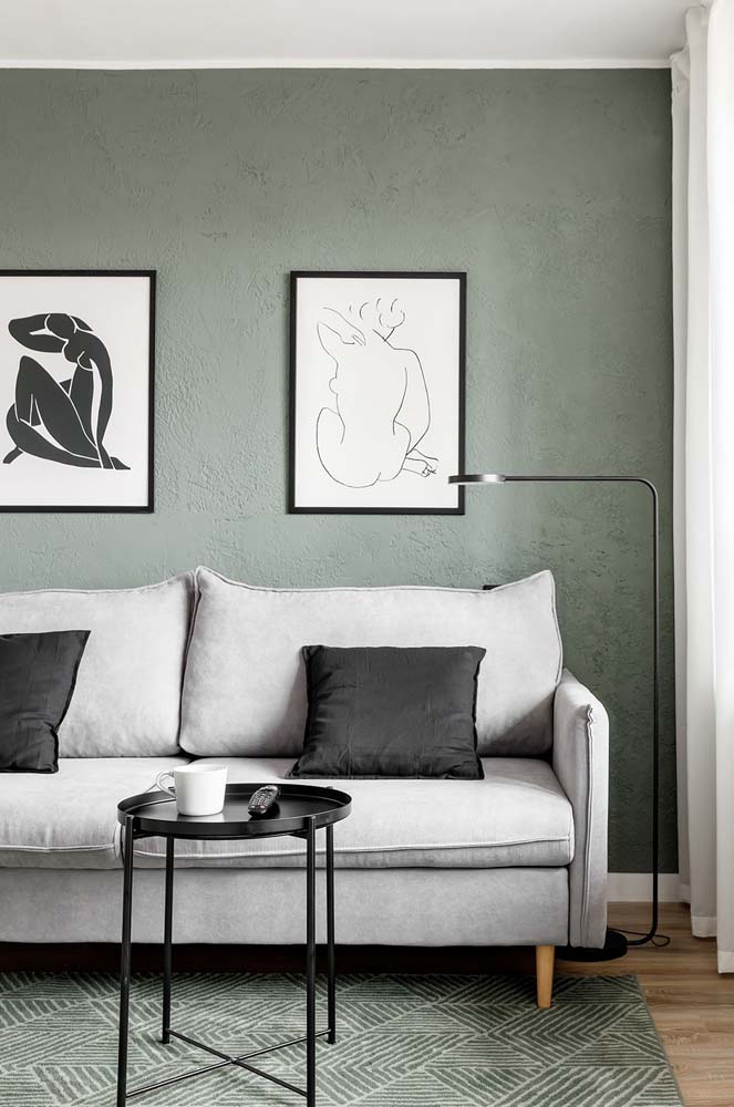 Na parede e no tapete, o verde musgo aparece em dose dupla nesta sala de estar moderna com sofá cinza claro.